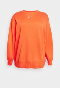 Nike orange sweatshirt, lång ärm, rundad halsringning, ribbade manschetter och nederkant, tillverkad av strukturerad tyg, med en liten vit logotyp framtill.