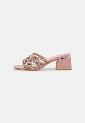 Sandalia de tacón bloque de ante rosa con puntera abierta y múltiples correas adornadas con rhinestones rosas y claros.