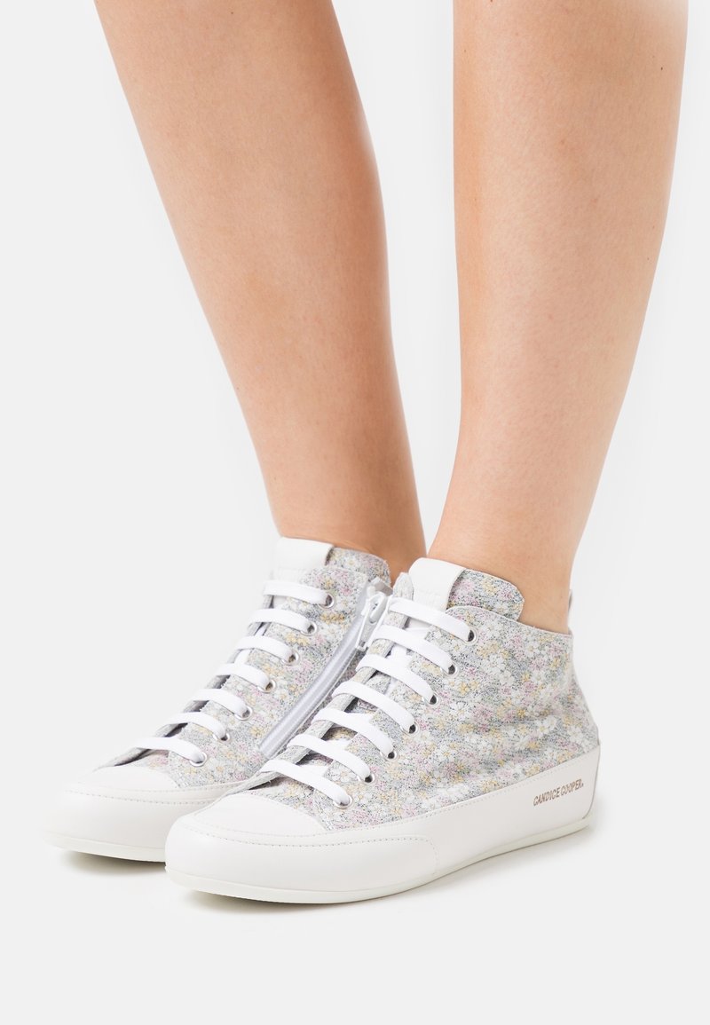 High-top sneakers with a multicolor floral pattern on textured fabric; white rubber sole and laces; zipper detail on the side.