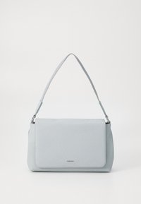 Light gray handbag with a textured finish, adjustable shoulder strap, and magnetic flap closure. Features a subtle brand logo on the front.