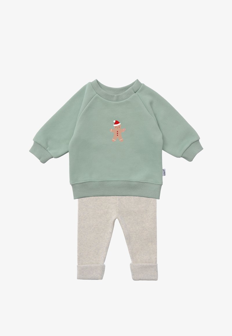 Green sweatshirt with gingerbread man print, paired with light gray ribbed pants, featuring rolled-up cuffs and soft fabric texture.