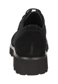 Scarpa in suede nera con suola spessa, caratterizzata da una punta arrotondata e un pull tab sul retro per facilitarne l'indossamento. Texture liscia e design semplice.