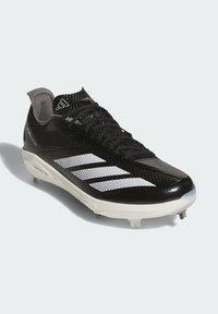 Black athletic shoe with mesh upper, white three-stripe design, textured finish, and molded studs on the rubber outsole for traction.