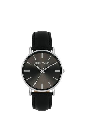 Black Tom Tailor wristwatch with minimalist silver hour markers and hands, round silver case, and black leather strap.
