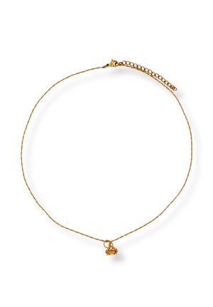 Delicate gold chain necklace with small orange gemstone crab-shaped pendant and adjustable clasp closure.
