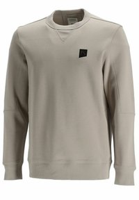 Světlé béžové tričko z měkkého materiálu, s kulatým výstřihem, žebrovanými manžetami a malým černým logem na levé straně hrudi.