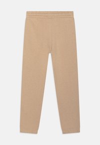 Beige Sweatpants aus einer weichen Baumwollmischung, mit elastischem Bund, schmal zulaufenden Beinen und gerippten Bündchen an den Knöcheln.