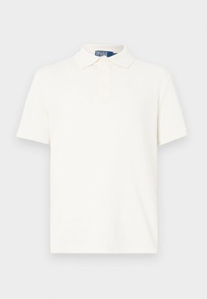 Krémové polokošeľa z textúrovaného bavlneného materiálu, s klasickým golierom, zapínaním na tri gombíky a krátkymi rukávmi. Bez viditeľných vzorov alebo zdobení.