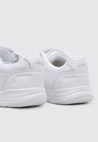 Zapatillas blancas con una parte superior de cuero liso y malla, que cuentan con una suela de goma texturizada, detalles con marca y un diseño de punta redondeada.