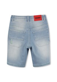 Lichte blauwe denim shorts met een versleten textuur. Heeft twee achterzakken, gestikte details en een rood label met "HUGO" op de tailleband.