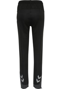 Schwarze Sporthose mit einem strukturierten Bund. Mit reflektierenden Chevron-Akzenten an den Bündchen und einem taillierten Design. Hergestellt aus einem dehnbaren Material.