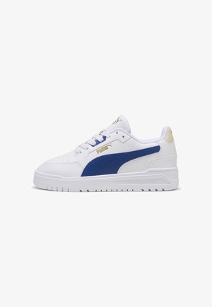 Baskets basses blanches Puma avec bande latérale bleue, logo Puma doré et semelle blanche, vues de côté sur fond blanc.
