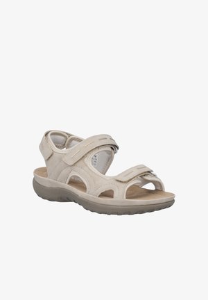 Beige sandal med åben tå med justerbare velcro-stropper, polstret indlægssål og struktureret sål til afslappet udendørs brug.