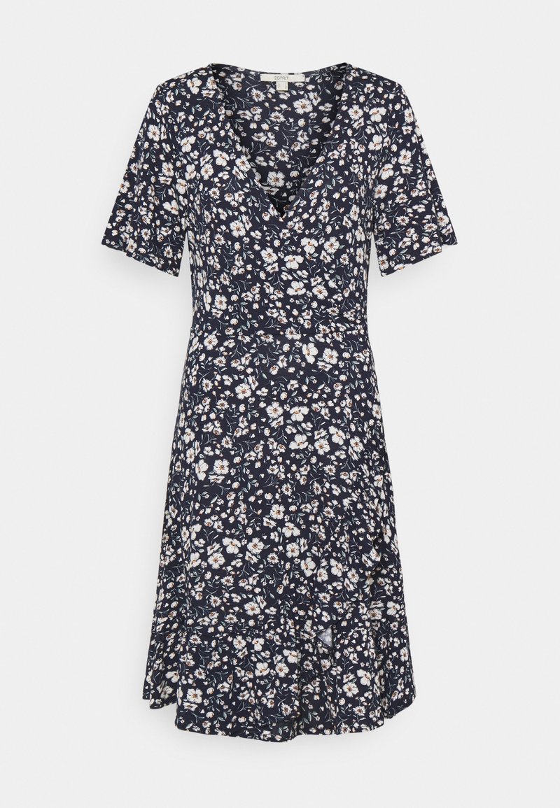 Robe bleu marine longueur genou avec imprimé floral blanc et beige, manches courtes et décolleté en V avec devant style cache-cœur.