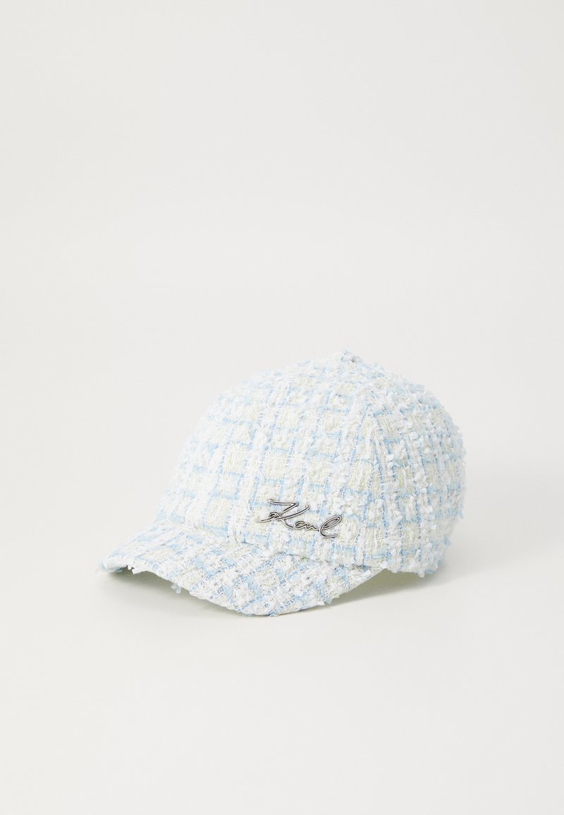 Light blue tweed baseball cap with textured check pattern and silver "Karl" embroidery on the front. Curved brim and structured shape.