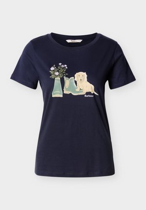T-shirt en coton bleu marine avec un graphisme de deux bottes en caoutchouc vertes ornées de fleurs et un chien beige assis à côté.