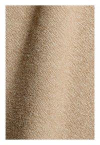 Tissu tissé beige avec une texture douce, légèrement duveteuse et des fils verticaux et horizontaux visibles.