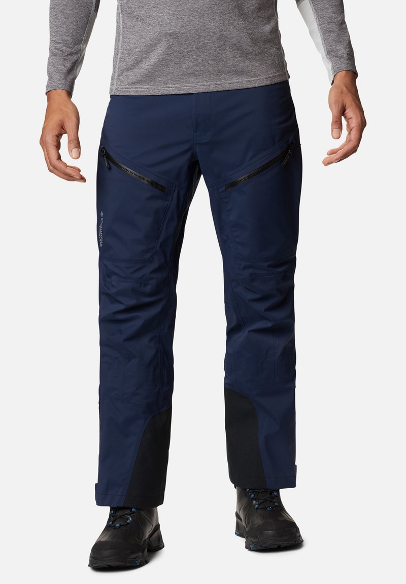 Marineblaue wasserdichte Skihosen mit Reißverschlusstaschen, verstärkten Säumen und einer körpernahen Passform. Das Material wirkt glatt und hat eine langlebige Textur.