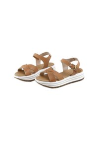 Sandalias abiertas de piel marrón con tiras ajustables en el tobillo con hebilla y suelas de plataforma blancas con detalles a rayas.