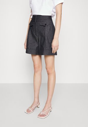 Szorty jeansowe o wysokim stanie w ciemnym kolorze, z dwiema przednimi kieszeniami, detalami z guzikami i ustrukturalizowanym fasonem, stylizowane z białymi sandałami na ramiączkach.