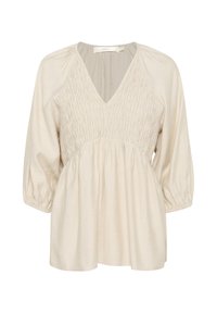 Blusa beige chiaro con scollo a V, dettagli plissettati sul bodice e maniche a tre quarti con polsini arricciati. Tessuto morbido e testurizzato.