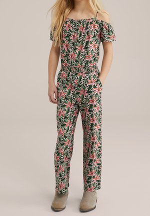 Blomstret jumpsuit med skulderskæringer, lavet af grøn stof, pink liljer og sorte prikker. Har elastisk talje og lommer.