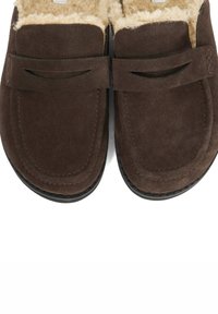 Brown suede slippers with a soft, fuzzy interior, featuring a stitched design and two horizontal accents across the upper.