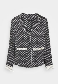 Camicia a maniche lunghe bianco e nero con un motivo ripetuto, colletto e polsini a contrasto, dotata di due tasche frontali e chiusura con bottoni.