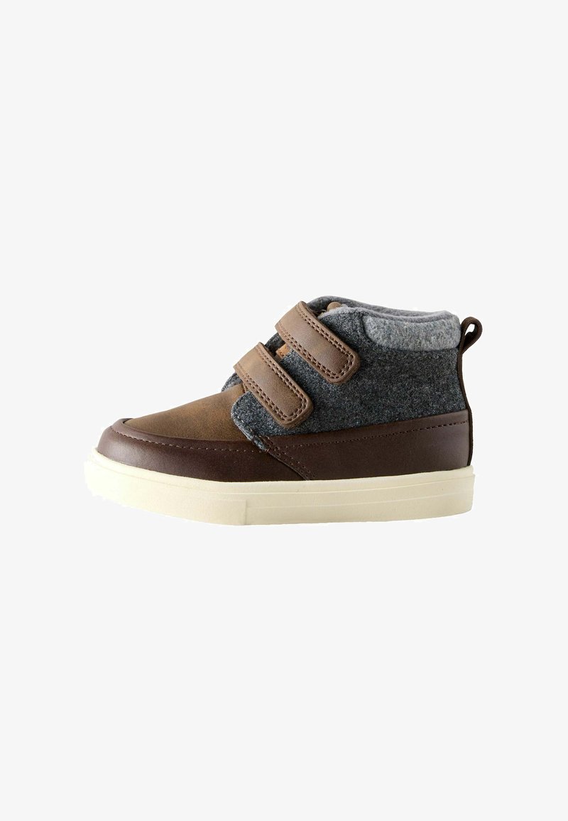 Zapato infantil marrón y gris de caña alta con dos correas de velcro y suela de goma blanca sobre fondo blanco.