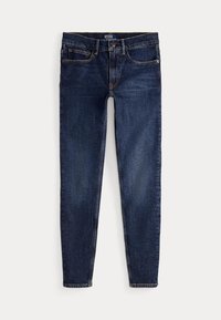 Tmavomodré slim-fit rifle s piatimi vreckami, zapínaním na gombík a zips a viditeľnými stehovými detailmi.
