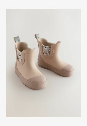 Beige gummistøvler med en struktureret overflade, runde tæer og et mønstret inderfor med bjørnemotiver. Inkluderer en trækskive for nem påtagning.