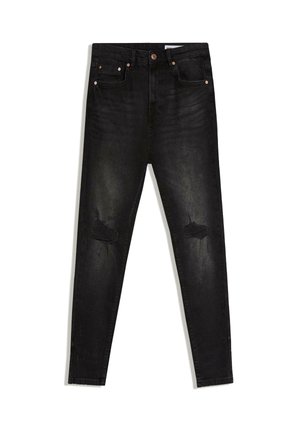Black skinny jeans with distressed patches on both knees, five-pocket style, and copper rivet details, laid flat on white background.