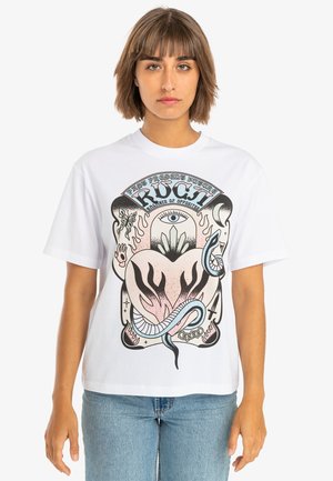White cotton t-shirt featuring a graphic design with an eye, flames, and snakes in pastel colors. Short sleeves and a relaxed fit.