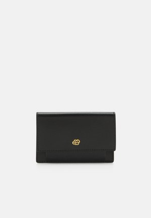 Black leather wallet with a smooth texture, folded design, and a gold logo accent on the front. Minimalist and compact shape.