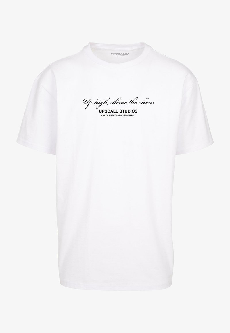White crew neck t-shirt with black text reading "Up high, above the chaos," "UPscale Studios," and "Art of Flight Spring/Summer 23" on front.