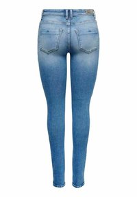 Vaqueros ajustados en denim azul claro, con un acabado desgastado, diseño de cinco bolsillos y un corte slim con detalles de costura a lo largo de las costuras.