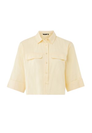 Camicia a maniche corte con colletto in cotone giallo chiaro, con due tasche sul petto, apertura con bottoni e polsini risvoltati. Tessuto liscio, design minimalista.
