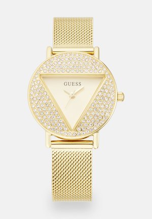 Goldfarbene Uhr mit einem dreieckigen Zifferblatt, umgeben von funkensprühenden Steinen, einem minimalistischen Ziffernblatt und einem strukturierten Mesh-Armband.