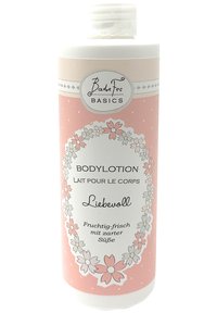 Body lotion in a pastel pink bottle with floral patterns and white accents. Features a flip-top cap and labeled with "BadeFee Basics."