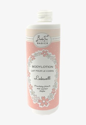 Body lotion in a pastel pink bottle with floral patterns and white accents. Features a flip-top cap and labeled with "BadeFee Basics."