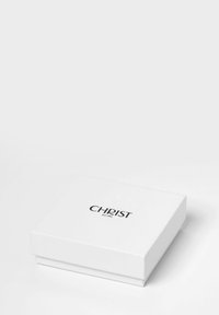 Hvid rektangulær gaveæske med en glat tekstur, der har et sort logo "CHRIST" og "est. 1863" trykt på toppen.