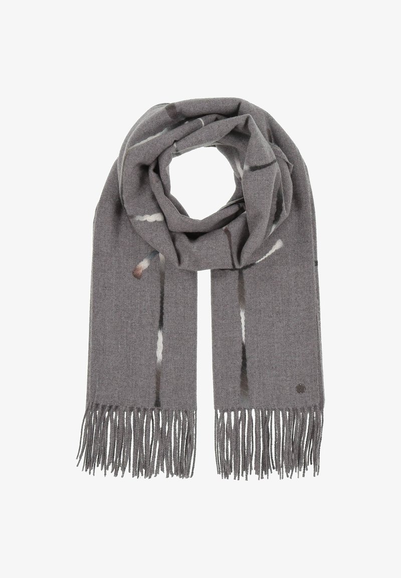Écharpe en laine grise avec des motifs abstraits subtils, des extrémités à franges et une petite étiquette métallique circulaire près d'un bord.