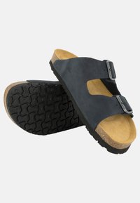 Sandali neri in pelle con due fibbie regolabili, soletta in sughero e suola in gomma textrurizzata per una migliore aderenza. Design aperto davanti.