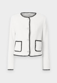 Vit långärmad jacka med svart zigzag detaljer längs kanterna och fickorna, framfällda silverknappar och rund halsringning.