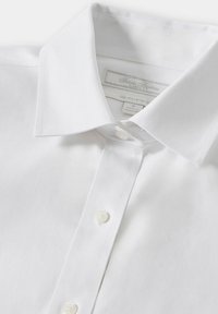 White, non-iron dress shirt with a classic fit, featuring a stiff collar, button front, and smooth, lightweight fabric.