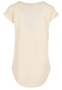 Beige short-sleeve top with a rounded neckline, textured fabric, and a longer back hem. Features rolled sleeves and a relaxed fit.