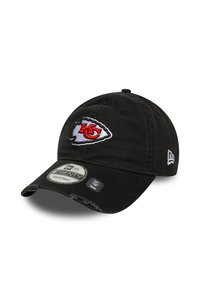 Black adjustable baseball cap with Kansas City Chiefs logo, New Era emblem, and NFL team sticker on the brim.