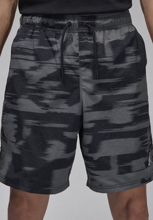 Svarta och grå mönstrade shorts med elastisk midja, dragsnöre och sidofickor. Tyget har en subtil lyster och en slät textur.