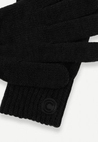 Juodos megztos pirštinės su gyslota apykakle, turinčios apvalų juodą logotipą. Minkšta tekstūra ir standartinio ilgio pirštai.