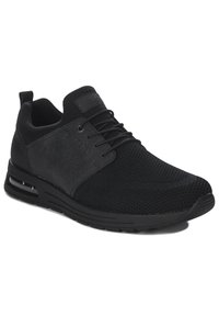 Black athletic shoes made of mesh and synthetic material, featuring a textured design, adjustable laces, and a padded ankle for comfort.
